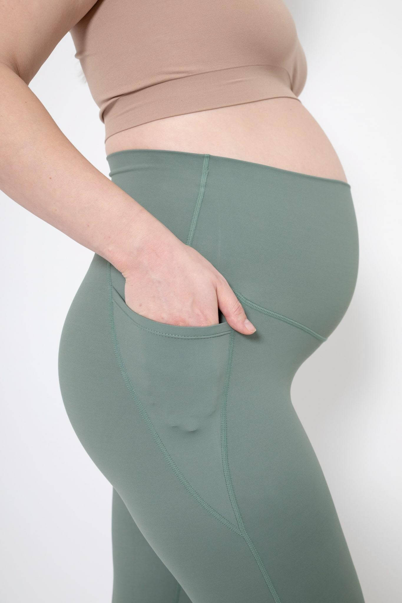 https://www.lunagray.co.uk/cdn/shop/products/Woman-wearing-the-Lyla-green-maternity-gym-leggings-pocket.jpg?v=1638306346