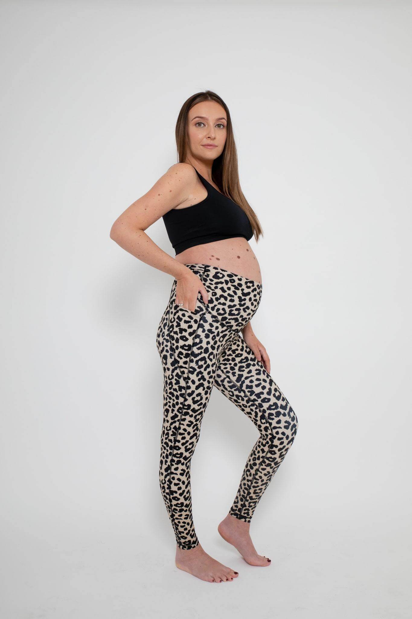 Woman wearing the hudson leopard print maternity gym leggings front on